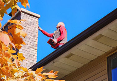 Bill Brannon, certified home inspector, visually inspecting the roof of a home.